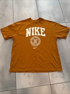 Nike Women’s Sportwear Essentials Short-Sleeve Graphic Tee in Rust Brown
